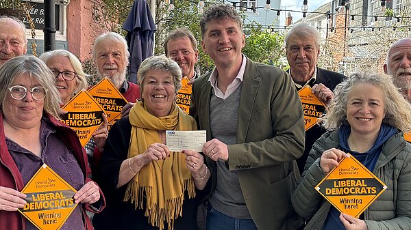 A group of Bridport & Chesil Bank Liberal Democrat Candidates and Councillors stood with Edward Morello stood outside the Bull Hotel holding 'Liberal Democrats Winning Here' window posters.