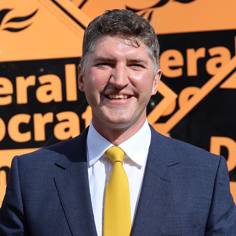 Edward Morello Stood in front of Liberal Democrat Stake Boards