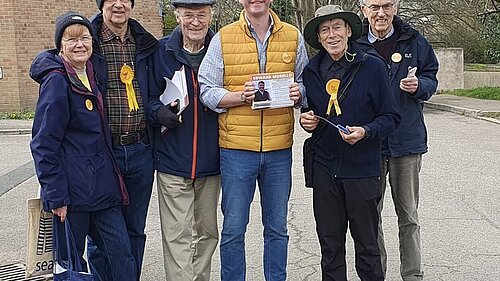 A Group of Lib Dem volunteers standing Smiling with Edward Morello