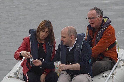 Cllr Sam Bennett and Jane Dodds MS test the water quality of the river Tawe
