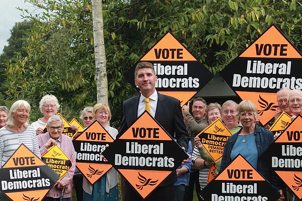 Activists with Parliamentary Candidate Edward Morello A group of activists with Edward Morello standing in the middle, all are holding Lib Dem orange placards