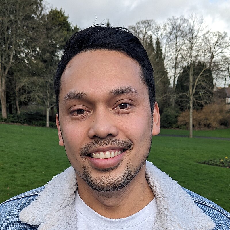 Jed Germodo wearing a white t-shirt and blue denim jacket with sherpa lining