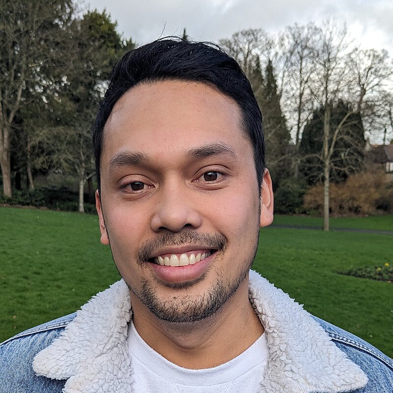 Jed Germodo wearing a white t-shirt and blue denim jacket with sherpa lining