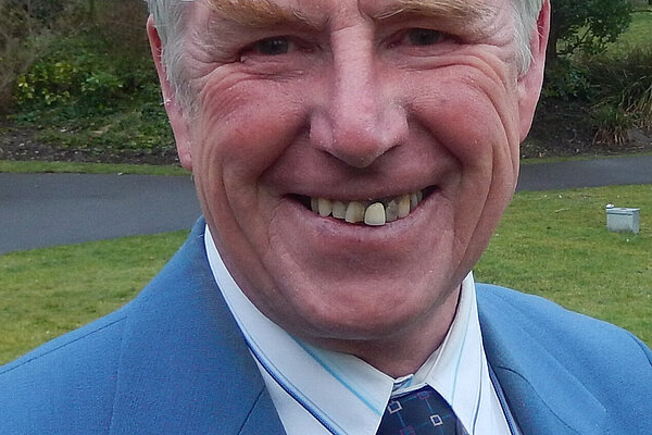 Robin Potter wearing a blue suit anf tie