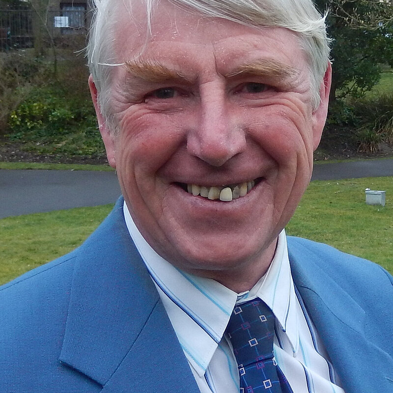 Robin Potter wearing a blue suit anf tie