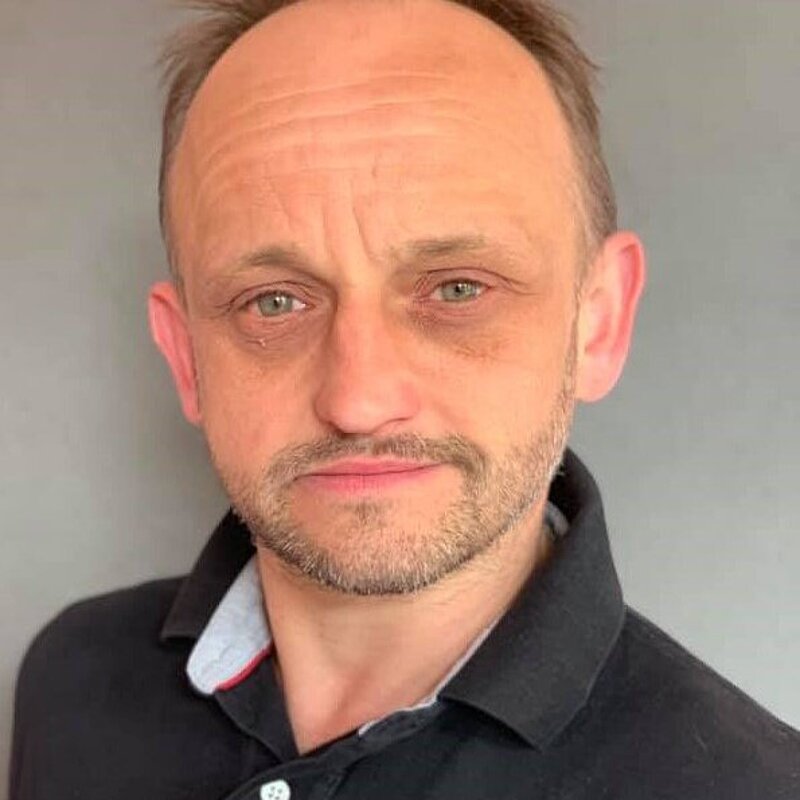 Ralph Ricardo wearing a black polo shirt