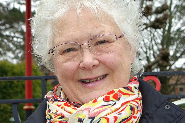 Molly Rennie in 2019 wearing a multicoloured scarf and blue jacket