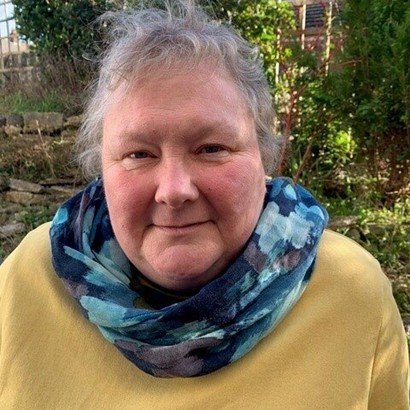 Fiona Kent-Ledger waering a blue scarf and yellow jumper