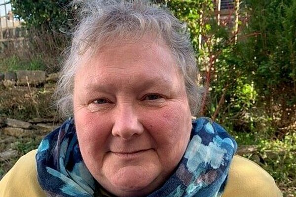 Fiona Kent-Ledger waering a blue scarf and yellow jumper