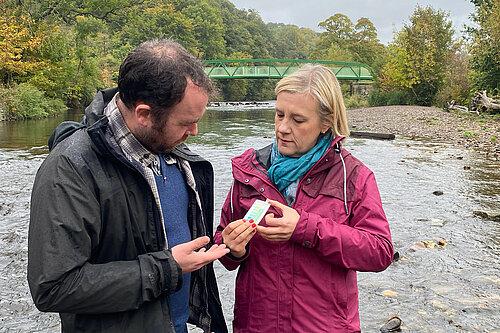 Lisa Smart MP and Cllr Mark Roberts testing water quality in the River Goyt